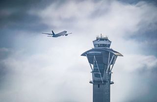 Airport control tower and runway infrastructure, representing UK air traffic controller recruitment context