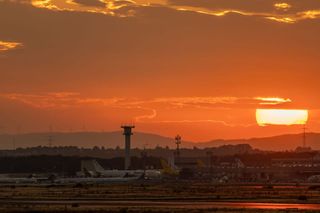 Commercial aircraft on an airport apron at sunset, representing Ryanair pilot recruitment